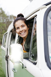 Young woman sitting in camperm looking out of window - HMEF00459