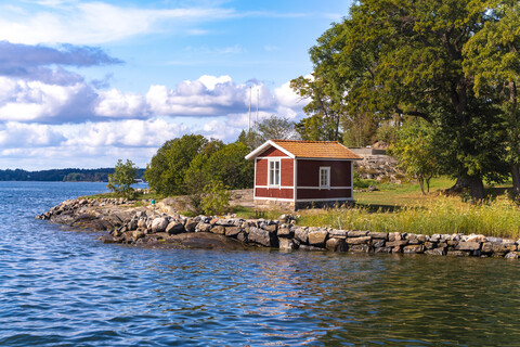 Holzhütte in traditionellem Rot in den Schären bei Stockholm, Schweden, lizenzfreies Stockfoto