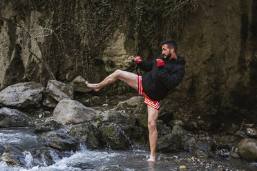 Young man doing boxing workout in nature - LJF00066