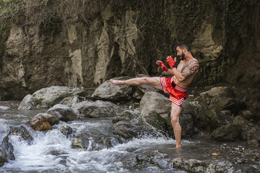 Young man doing boxing workout in nature - LJF00067