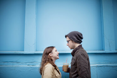 Couple standing near blue wall - BLEF05782