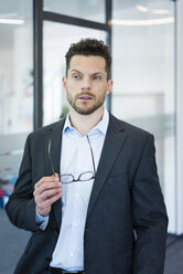 Portrait of thoughtful businessman in office - MOEF02172