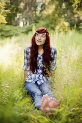 Girl wearing flower crown in rural field - BLEF05975