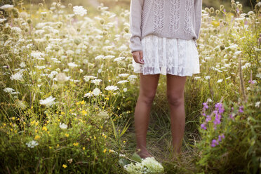 Woman standing in tall flowers - BLEF06015