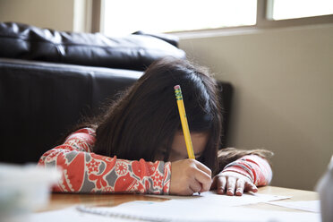 Nahaufnahme eines gemischtrassigen Mädchens bei den Hausaufgaben - BLEF06136