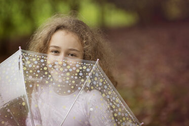 Caucasian girl playing with umbrella outdoors - BLEF06174