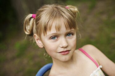 Close up of smiling girl siting in backyard - BLEF06228