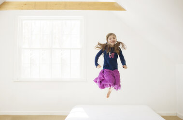 Kaukasisches Mädchen springt auf Bett - BLEF06241