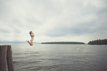 Caucasian girl jumping in remote lake - BLEF06252