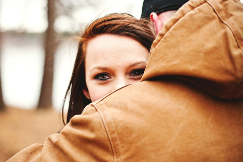 Close up of couple hugging in park - BLEF06319
