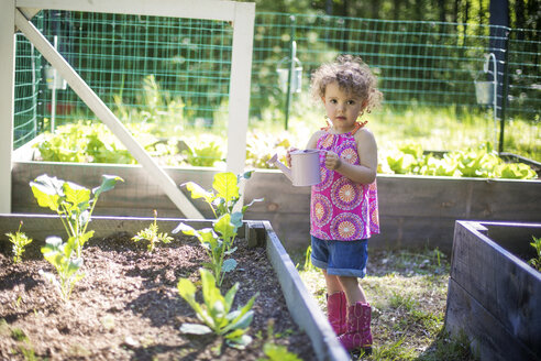 Mädchen bewässert Pflanzen im Garten - BLEF06362
