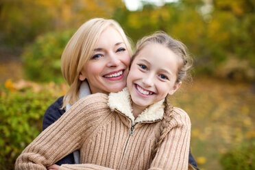 Mother and daughter hugging outdoors - BLEF06391