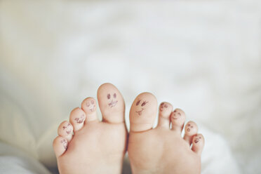 Toes of Caucasian girl with smiley face drawings - BLEF06468