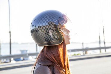 Caucasian woman wearing motorcycle helmet - BLEF06618