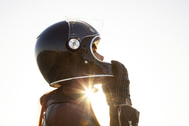 Caucasian woman wearing motorcycle helmet - BLEF06621