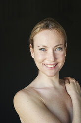 Portrait of smiling woman, strapless, black background - PNEF01520