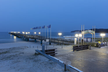 View to lighted sea bridge in the evening, Binz, Germany - WI03930