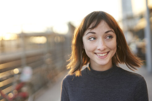 Portrait of smiling young woman at evening twilight - PNEF01569