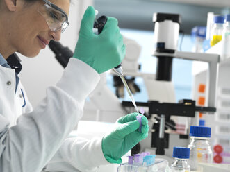 Biotech Research, Scientist pipetting sample into a vial ready for analysis during a experiment in the laboratory - ABRF00403