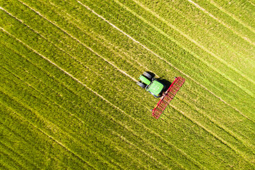 Aerial view of tractor on field, soil loosening, Hochtaunuskreis, Hesse, Germany - AMF07071