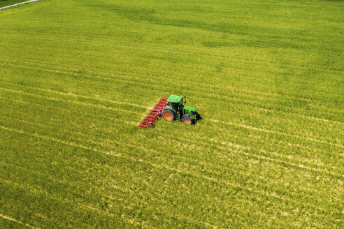 Aerial view of tractor on field, soil loosening, Hochtaunuskreis, Hesse, Germany - AMF07073