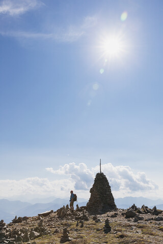 Wanderer am Aussichtspunkt mit Steinmännchen, Lammersdorfer Berg, Nockberge, Kärnten, Österreich, lizenzfreies Stockfoto