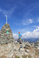 Hiker at viewpoint with cairn, Lammersdorf Mountain, Nock Mountains, Carinthia, Austria - GWF06088