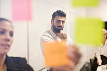 Young businessman with colleagues concentrating in meeting at office - MASF12398