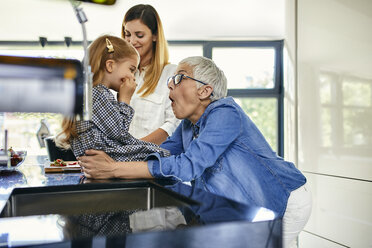 Mother, daughter and grandmother having fun in the kitchen - ZEDF02331