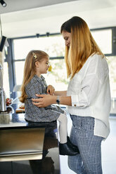 Mother and daughter in kitchen, smiling - ZEDF02338