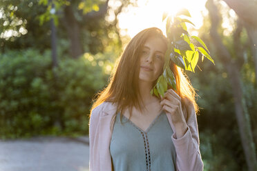 Young redheaded woman with leaves in a park - AFVF03201