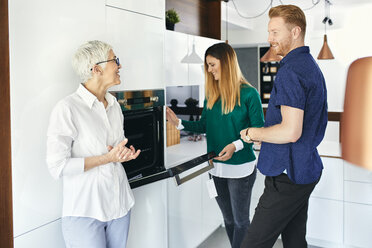 Couple shopping for a new kitchen in showroom - ZEDF02421