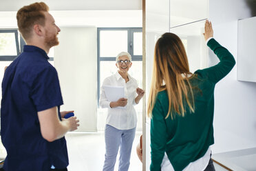 Couple shopping for a new kitchen in showroom - ZEDF02425