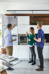 Couple shopping for a new kitchen in showroom - ZEDF02438