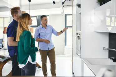 Couple shopping for a new kitchen in showroom - ZEDF02439