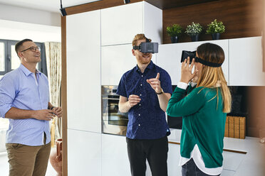 Couple wearing VR glasses shopping for a new kitchen in showroom - ZEDF02442