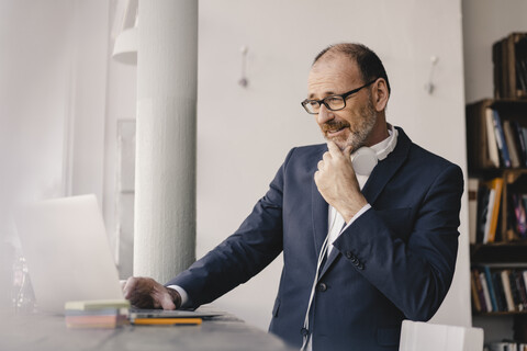 Mature businessman using laptop in a cafe stock photo