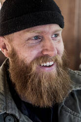 Portrait of smiling bearded man with light brown hair, wearing black beanie. - MINF11297