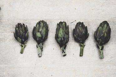 High angle close up of fresh artichokes on grey background. - MINF11352