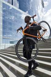 Man carrying his bike - JND00058