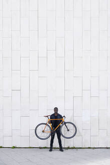 Man holding his bike - JND00078