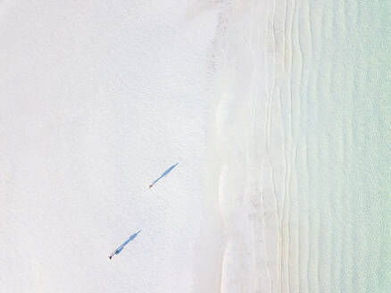 Two people and their shadows at a beach with crystal clear water seen from above, Yucatan, Mexico - MMAF00969