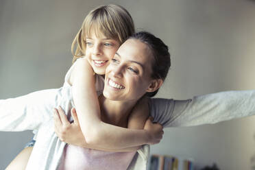 Mother and daughter playing at home, pretending to fly - JSRF00187