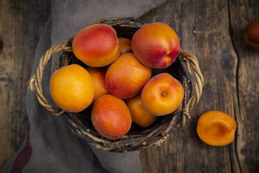 Apricots in basket on dark wood - LVF08080