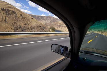 Car driving on road through Yakima River Canyon, Washington, United States - MINF11619