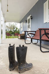 Dirty wellingtons on front porch - MINF11624