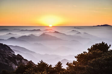 Fog rolling over rocky mountains, Huangshan, Anhui, China - MINF11699