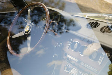 Vintage Ferrari dashboard viewed through window - MINF12043