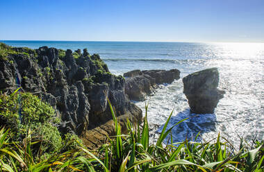 Backlight of huge rock in the ocean, Pancake Rocks, Paparoa National Park, South Island, New Zealand - RUNF02668