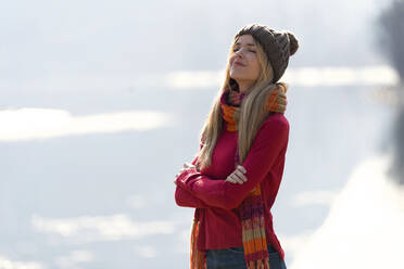 Young blond woman at a lake in winter - JSRF00206